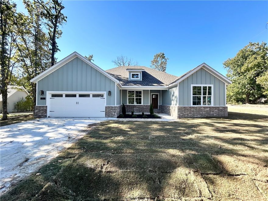 MOVE-IN READY! Craftsman style new construction on a large flat .41 acre corner wooded lot! You can enjoy peace and privacy, as there is a substantial wooded tract owned by the HOA directly behind the house, ensuring a home can not be built behind you.  Perfectly situated just minutes from Lake Loch Lomond, Highlands Golf Course, Branchwood, and provides quick access to I-49! Step inside to discover a beautifully designed interior with 3BD's + office and a split-floor plan. The spacious living area showcases vaulted ceilings with elegant beams, creating an inviting atmosphere. The kitchen features sleek 3 cm quartz counters, a gas range, custom cabinets, and stylish black stainless-steel appliances. Retreat to the luxurious primary bath, which boasts a huge walk-in closet, a large custom walk-in tile shower, and a soaking tub. Covered deck. As an added bonus, receive $3,500 towards buyer's closing costs when working with the builder’s preferred local lender!
