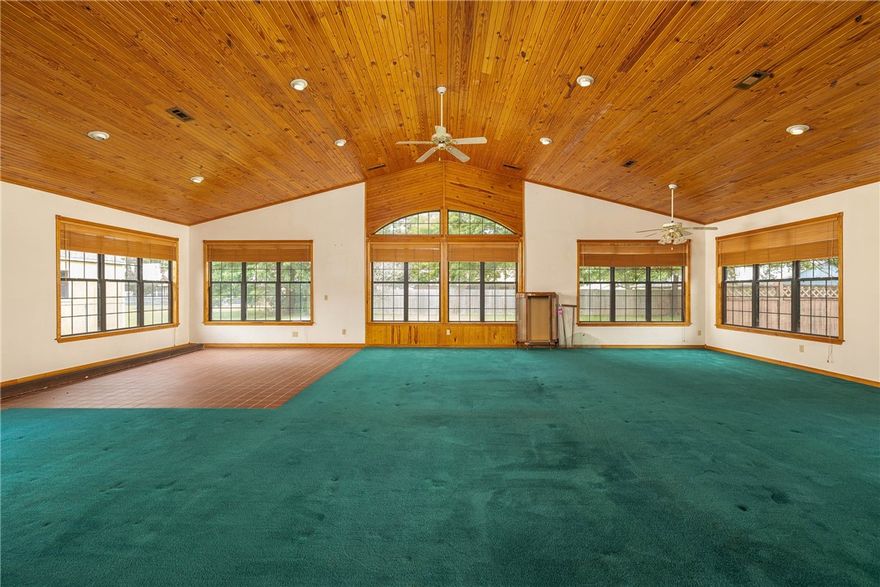 Start your next chapter in this spacious 3-bed, 2-bath home nestled on a quiet neighborhood circle. With nearly 3000sf of living space & generous .35 acre flat lot, this home is bursting with potential & ready for your personal touch/updates!
Step inside to avaulted living room anchored by a native stone hearth & fireplace for your cozy evenings. French doors from the great room lead you out to a fully fenced interior courtyard & an expansive backyard, complete with a gorgeous, mature oak, concrete pad for your storage building or workshop, & a perfect spot to unwind, entertain, garden, or plan your future pool/oasis.
You’ll love the huge great room with soaring ceilings—so many possibilities for entertaining or creating additional living spaces. While not techically handicap accessible, there are no steps inside the home, and minimal on the exterior. 
Phenomenal location next to JB Hunt Park, .4 mile to the Razorback Greenway, .5 mile to Lake Springdale, & 10 minutes to I-49, making commutes & errands a breeze.