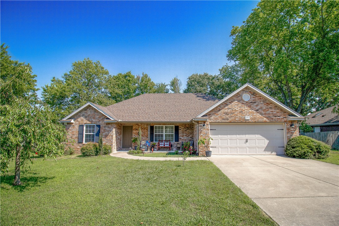 Well-maintained brick home with 3 bedrooms and 2 bathrooms, offering a split floor plan for privacy. The living room’s vaulted ceiling and wood flooring add elegance, and the kitchen’s large size includes an eat-in bar, granite counters, and stainless steel appliances. The home sits on a large, fenced lot with mature trees, a covered patio, and an expansive deck — ideal for relaxing or entertaining.The two-car garage provides easy access to an attic with a floored area for additional storage space. Features a charming wood swing and a 10x20 storage building that conveys. Move-in ready and waiting for new owners!