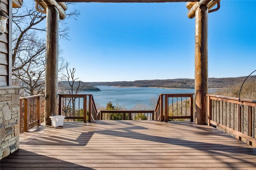 Escape to this remarkable lakefront home with separate guest house on Beaver Lake, capturing the essence of refined living in a serene setting. Stepping inside, you are greeted by a grand foyer featuring a soaring ceiling with exposed log beams, exotic Hawaiian hardwood flooring & custom staircase w/local artist-made iron railing, all of which showcase the craftsmanship of the home. The open-concept living seamlessly integrates the living areas, providing a spacious & inviting atmosphere with oversized windows framing breathtaking views of the lake. The gourmet kitchen showcases top-tier appliances, custom cabinetry & large island. Adding to the allure of this property is a separate charming guest house, providing a private retreat for family & guests. The many outdoor living spaces feature expansive decks that provide the ideal vantage point for enjoying year-round Beaver Lake views. This property includes boat slip with lift in a community boat dock.  Guest house sq ft of 1,320 is in addition to the total sq ft.