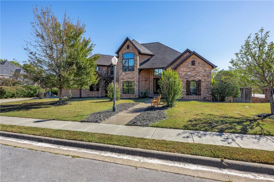 Custom Built Home in the Exclusive North Bentonville Neighborhood of Heathrow!  Executive neighborhood and prime location with direct access to the North Bentonville trail connections for biking and walking!  Beautiful Home with .55-acre lot, private backyard with outdoor covered living space and fireplace. Terraced landscaping and backyard with multiple outdoor areas for play or entertaining including a built-in fire pit and hot tub to convey!   Open concept floorplan with soaring ceilings, lots of natural light, kitchen featuring custom cabinets, large eat in area, coffered ceilings with an adjacent wine cellar!  Hand scraped wide plank wood flooring. 6” exterior walls. Reward yourself with this custom beauty in this Established and Treasured North Bentonville Neighborhood with prime location-minutes to I-49, 5 min to Downtown Bentonville, Crystal Bridges, and the Walmart Home Office.