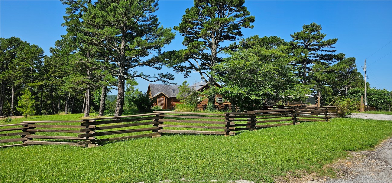 The views from this wonderful log home on 8.61 acres are spectacular. Located just 5 minutes from downtown Eureka Springs. There are raised beds for vegetables or flowers. The shop is approximately 1200 square feet that has unfinished plumbing that can made into a bathroom and extra room to add living space or keep for your toys. You are surrounded by the beauty of the Ozark Mountains and no restrictions as to what you can do with the property. And only 15 minutes to the nearest Walmart.