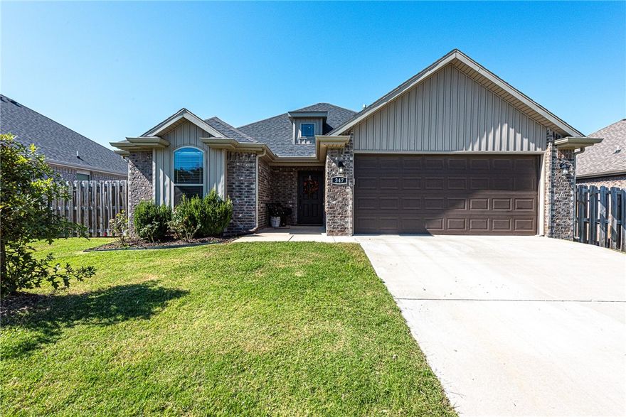 WELCOME HOME! Built in 2021, this 3 bedroom 2 bathroom home is located near schools, shopping, eateries, and minutes away from I-49 and the University of Arkansas! From the porch head inside into an open-concept living room featuring 9ft ceilings,  luxury vinyl plank floors throughout the main living space, a gas log fireplace, and Crown Molding details! Flow into the eat-in dining room and galley kitchen featuring: granite counters, upgraded single basin sink, Subway tile backsplash, stainless steel appliances, ample cabinet space, and counter height peninsula! The laundry room includes an upgrade for cabinet storage and a drying rod! Relax and rejuvenate in the primary bedroom with a private ensuite feat: double sink vanity, whirlpool tub combo, and two walk-in closets! Enjoy two additional bedrooms and one additional bathroom! Out back enjoy the covered back patio and fully fenced back lawn perfect for the remaing Fall months Don’t Miss Out! Act Now!