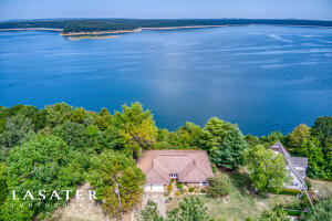 Come see why life is better at the lake! Located at one of the premiere locations for a lake home in Diamond City, this 2 bd, 2 ba home is a must see! While the nicely maintained living room and dining area add to the cozy charm of the home, it's the den that could easily become the favorite room in the house: featuring a wood-burning fireplace, and extra-large windows from which to take in some of the best views of the lake, it's sure to captivate you! A screened-in porch, and a deck that spans the length of the back of the home, ensures that whether you are enjoying the lake life from inside or out, you can relax in comfort, while surrounded by natural beauty. As a bonus the home is on city water and a well. Taxes are after Homestead Credit. All #s approximate.''