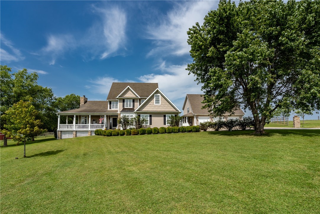 Your own piece of Southern Living. This home looks like it stepped straight out of the pages of the
magazine! With 5 beds, 2.5 baths and over 3,600 sf in the beautiful main home, you will enjoy watching the horses graze and the sun come up from the wrap around porch on crisp fall mornings. Complete with office space, a craft or reading nook, walk in closets, and generous entertaining areas, this is a welcoming Arkansas home at it's finest! In the well appointed guest home, you will find an open floor plan with room for grandparents,a place for the kids to stay when they visit or potential rental income! The downstairs bath is handicap accessible and the upstairs you will just have to see it to believe. In addition to the upper living, bed & bath, there is an incredible walk-in attic storage area that could easily be finished into add'l living space. Outside find a 4-stall horse barn, chicken coop, fruit trees, blackberry bushes, and RV pad w hookups! So much to see & appreciate! Don't let all this charm slip away!