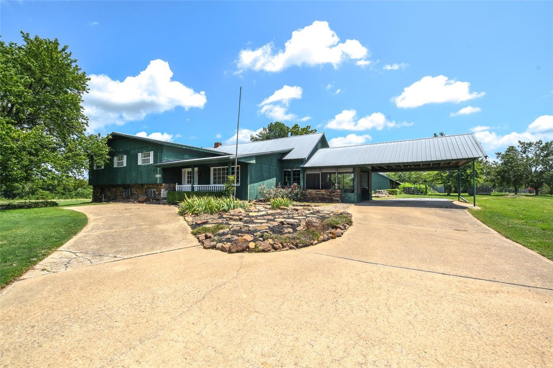 MIDCENTURY MODERN style home! AMAZING LOCATION WITH 3.43 +/- ACRES! Fabulous setting on the edge of City limits! Receive all of the amenities of being in the City-public water, electric, gas, etc but feel like you are living in the country! Animals ARE allowed! Large home with a screened in porch, a deck off the primary bedroom, and a large back patio that is perfect for hosting friends and family get togethers! Also two large outbuildings on the property-One is 60 x 19 & other 50 x 40. It is possible to build additional homes on the property..City would have to approve and sellers would like to also know intended plans. Close to schools, downtown Siloam, Siloam City Lake, which includes great walking/biking trails, fishing, kayaking, frisbee golf etc. There is also a full walk out basement in this home and a cellar -great spaces for storm protection! This property has been well loved by one family for many years. HGTV contact did reach out & they have interest in this property for a show!