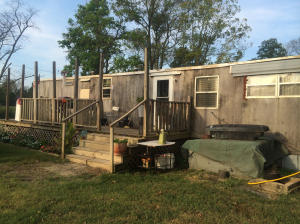COUNTRY LIVING WITH MOBILE HOME!!! 3 Bedroom and 1 Bath with 1.30 acres plus a SHOP! Lots of yard front and back and a storm cellar. POSSBILE OWNER FINANCE!