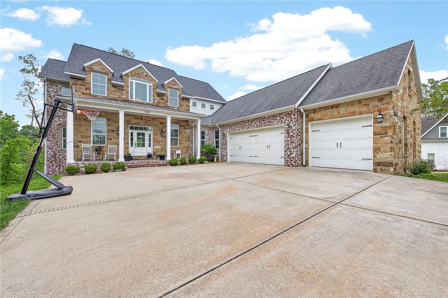 Experience luxury living in the prestigious Versailles neighborhood with this stunning custom-built home designed for both elegance and functionality. The open-concept kitchen, living, and dining areas create a seamless flow ideal for entertaining, while expansive windows showcase beautiful wooded views and fill the home with natural light. Upstairs, the private primary suite offers a relaxing retreat with a spa-like ensuite bathroom, while two additional bedrooms are connected by a Jack-and-Jill bathroom. The finished walkout basement adds exceptional versatility with a large bonus room, abundant storage space, and a gym area already plumbed and ready for the option of a future kitchenette—perfect for guests, multigenerational living, or entertaining. You will also find two additional bedrooms and full bath. Enjoy privacy, scenic surroundings, and the convenience of being near downtown Bentonville, bike trails and more! See MLS #1345394 for the 1.5-acre home offering without the adjoining lot included.
