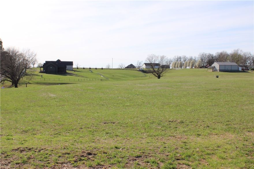 Nestled in a quiet subdivision in Tontitown, this beautiful 1.88-acre lot offers the perfect blend of space, privacy, and convenience. Featuring gently rolling hills and several mature trees, the property provides a picturesque setting for your future home while still allowing plenty of open space to design the layout you’ve always envisioned.

Located in a small subdivision with larger estate-sized lots, the property includes protective covenants to help maintain the quality and character of the neighborhood. Water, electric, and natural gas are available at the street, and a septic system will be needed.

With a minimum build requirement of 2,500 square feet, this lot is ideal for creating a spacious custom home surrounded by nature. Enjoy peaceful country-style living while still being just minutes from the conveniences of Northwest Arkansas.

Bring your builder and start planning your dream home today.