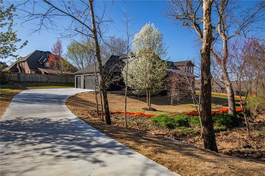 Dare to be different...in this contemporary beauty!  Natural boulder walkway leads to porch w/ rough cedar rafters.  The grand entrance thru 6080 steel frame glass front door opens to the living/dining/kitchen.  Gourmet kitchen includes black Nero Marquina Quartz counters, Fridgaire professional appliances with cafe' gas range & fridge & large walk-in pantry.  Chesterton white oak 5/8" hardwood floors, w/ 1/2" large format porcelaln tile floors in baths/mud/laundry areas.  Floating white oak stair treads takes you to the office/bonus room. Fireplace changes colors for ambiance. Hidden storage behind built-in shelves. Laundry chute in upstairs bath for convenience. Exterior: Hardie board/brick & natural stone wainscoat, gridless black windows, designer exterior uplighting, 2 covered porches, plus oversized 3 car garage are just a few of the amenities for this exquisite home.