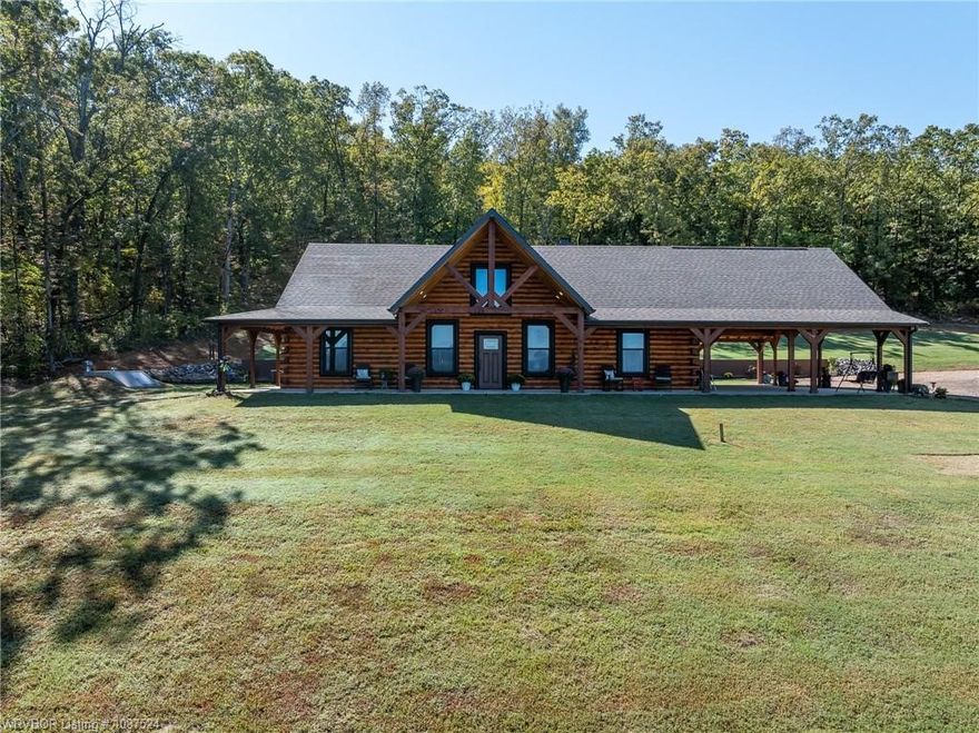 Builder’s personal custom log home on 6.22 acres with breathtaking north-facing views of the Ozark Mountains (White Rock area). This thoughtfully designed home offers approximately 2,200 heated square feet & nearly 4,000 square feet under roof, w/ 3 bedrooms and 2 baths on the main level plus two loft rooms upstairs, providing flexible space for additional sleeping areas, office space, or hobbies. The property also features a 24x40 heated and cooled guest house/shop complete with a full kitchen and bathroom, making it ideal for guests, extended family, or a private workspace. The shop includes 12x40 lean-tos on both sides. Both the home and shop are fully foam insulated, contributing to very low utility costs. The home features dual-zone HVAC systems along with a wood stove, as well as commercial-grade appliances in the kitchen and granite throughout. Conveniently located just 2–3 miles west of Ozark, approximately 15–20 minutes to the Mulberry River, 35 minutes to Fort Smith, and less than an hour to Fayetteville.