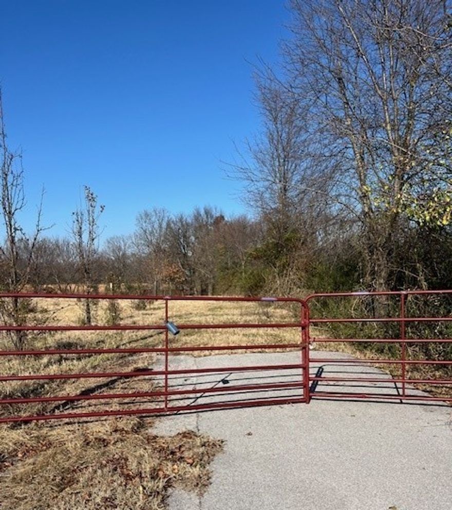This is the land you've been looking for to build your dream home! 5+ acres of rolling pasture with beautiful mature trees, and a wet weather creek and pond.  Prime location offers easy interstate access, nearby shopping, and is convenient to area schools and the stunning 120-acre Shaw Family Park. Land is cross-fenced and gated and is a perfect place for your estate home with workshop or a hobby farm, already complete with mature fruit trees.