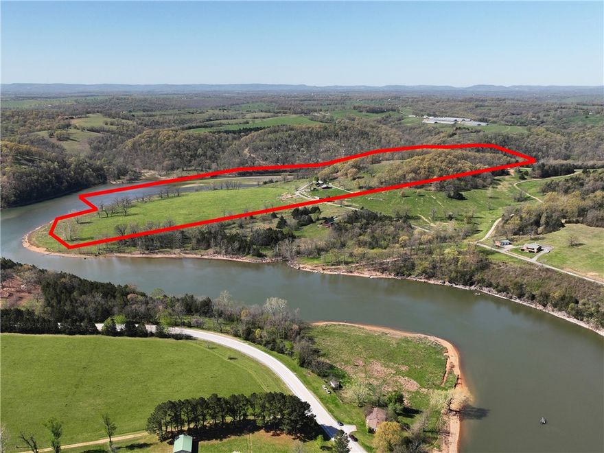 Rare opportunity to own 34 cleared, fenced acres with both Table Rock Lake frontage and Yocum Creek access. Ideal for livestock or horses, this property offers abundant waterfowl and wildlife and includes a 1970-built residence sold as is with 2,080 sq ft on the main level plus a walk-out basement with additional living space for a total of around 3200 sqft. A stunning hilltop behind the original homesite provides a premier building location with panoramic lake views. Just minutes from the Enon Boat Ramp for easy lake access and perfectly situated between Berryville, AR and Branson, MO. Incredible potential for a family retreat, nightly rental, or resort-style development showcasing the lakefront setting.