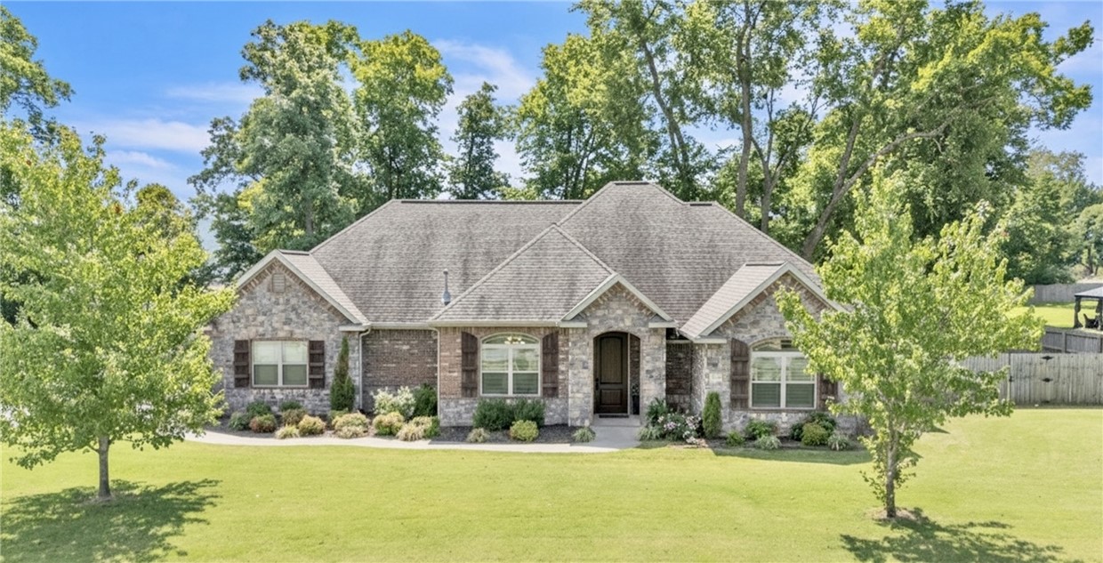Welcome to this stunning one-level, split floor plan home on nearly an acre in the highly desirable Twin Falls subdivision. The expansive backyard is a true retreatāenjoy the shade of mature trees, relax by the fireplace, or entertain guests under the covered patio (wired for TV) while cheering on the Hogs. Inside, the kitchen is a chefās dream, featuring a double oven, gas cooktop, spacious walk-in pantry, and plenty of storage. The open living area boasts vaulted ceilings, a brick fireplace, custom built-ins, and an inviting, airy feel. An oversized utility room with direct access from the large walk-in primary closet adds extra convenience. Donāt miss the chance to be just the second owner of this exceptional home!