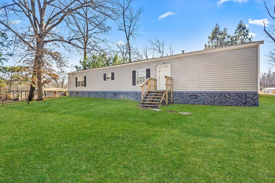 Escape the noise and settle into serenity with this stunning, move-in-ready mobile home. Perfectly positioned amongst a lush canopy of mature trees, this property offers the rare gift of total tranquility without sacrificing modern convenience. Step inside to an open and functional layout designed for easy living and effortless entertaining. The spacious interior feels airy and bright, centered around a thoughtfully designed eat-in kitchen that features center island, matching appliances, and ample storage with pantry. Split-bedroom floorplan ensures maximum privacy and functionality for everyone. Covered back porch gives the perfect vantage point to enjoy the sights and sounds of nature. Claim this beauty today!