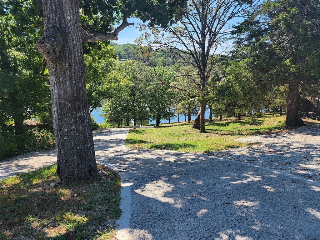 Discover a one-of-a kind lakefront home on beautiful Tablerock Lake! Built with 65 tons of steel and 625 yards of 4000 psi concrete, this 3 bedroom 2 bath, 2100 sq ft home is as solid as they come...bunker-strong, energy efficient, and built to last. Currently a basement/berm style house, it offers the option of adding a main level if desired. Step outside and enjoy incredible panoramic lake views and an easy walk to the water's edge. Inside, you'll find an immaculate layout with spacious living areas and a large garage for all your lake toys. Located just across the border from Branson, MO this Arkansas retreat gives you the best of both worlds-quiet lakeside living with the entertainment, dining and shopping of Branson just minutes away. A rare opportunity to own a beautiful home that's built like a fortress, on the shores of Table Rock Lake. (10 x 26 boat slip is available, but not included.)