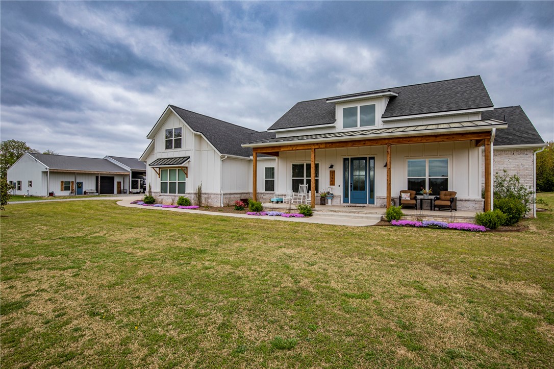 This is country living at it's finest. Bentonville School Dist. 1.8 miles from Hwy 102 to the property. This newly built custom home features a Farm House style that is practical and full of charm. Stunning design details are abundant throughout with and 18' tall foyer, 10' ceilings, vaulted ceiling in living area with decorative wood beams, accent walls, shiplap, granite & quartz tops, carefully selected textures and lots of natural light. Details were not ignored with this floorplan w/ oversized rooms including wider doorways making the space feel abundant. There is a space for a home office w/ closet or formal dining area. The additional 1,720 sq ft building has a 946 sq ft living space equipped with full bathroom and utility hook-ups. The building has an additional 18x43 garage with 10' overhead door, 24x50 parking for RV storage w/ 50 amp hook-up. 18x24 lean-to shed for livestock and extra equipment storage.