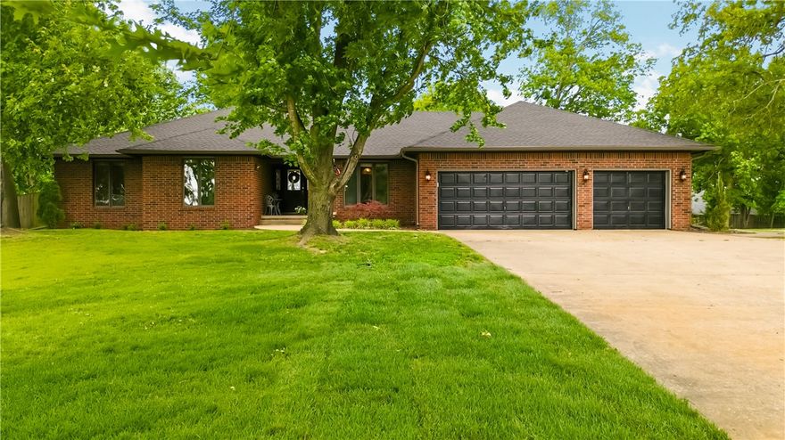 Stunning 4-bed, 3-bath brick home in one of Bentonville's most sought-after neighborhoods on a half-acre corner lot. Finished basement with second living area and kitchen, two fireplaces, granite counters, and circular driveway. Freshly painted garage doors (2026), new roof and gutters (2024), new pool liner (2025). Private backyard pool oasis — four-mile bike ride to the new lift at OZ Trails Bike Park — minutes from Walmart HQ, downtown, and I-49. Fantastic Airbnb or short-term rental opportunity!