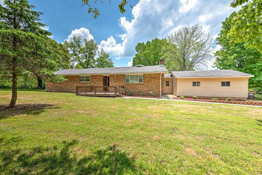 The best of both worlds...convenient location with a charming, country setting! 16 minutes to downtown Rogers or Lost Bridge marina. 30 minutes to Bentonville square or Eureka Springs. Well-built brick, ranch home has new flooring, paint, fixtures, shower floor, and landscaping. New roof (with 5-year warranty) installed May 2025. Fireplace insert has blowers, and hvac is 3-ton commercial unit. The back porch is spacious and ready for enjoying Arkansas summer evenings. Back yard is fenced and cross-fenced for animals. Tack barn previously housed mini horses. Attached workshop has water & electricity. Enjoy 1.35+/- acres of endless possibilities!