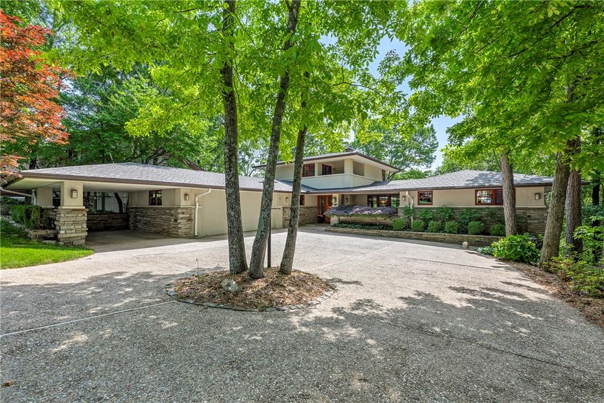 Discover luxury & tranquility at this exceptional, recently refreshed custom prairie-style home on the pristine shores of Lake Ann in beautiful Bella Vista. Located 220 yards from the Back 40 Trail, 10 min. to Bentonville & 20 minutes to the new Walmart Campus! This rare offering presents a unique opportunity to own a slice of paradise, meticulously crafted with the finest materials & showcasing great attention to detail. Recently landscaped grounds & refinished floors complement the home's already impressive features. Walls of windows frame breathtaking lake views & fill the home with natural light. Indulge in a wealth of high-end amenities: rich hardwood floors, elegant travertine tiles, natural stone accents, a private lakeside bungalow, chef's-grade appliances, a convenient motorized lift for effortless access to lake, & an add'l 500sf for a home office or craft room. Experience the ultimate in lakeside living at this remarkable estate.