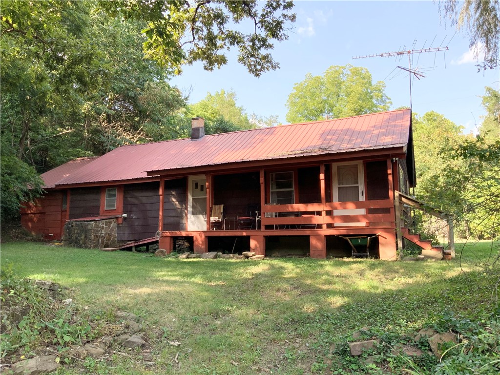 Enjoy the peaceful setting of this charming cabin nestled along a creek. Inside you find 1284sqft of open concept living area and 3br/1ba, all updated with fresh farmhouse touches. Glimpses of the original features throughout the home lend to the character and warmth. Cellar accessed from kitchen for cool storage or safe room. Outdoors you find 7.6 acres in a park-like setting with Maxwell Creek running along the property and a year-round spring providing water for the home. Rural water is available at the road. Approx 2.5 acres open/5.1 acres wooded with plenty of room to enjoy the outdoors. Foot paths through the woods and open ground for animal grazing. Original smoke house with useable storage space. Unique bridge access as well as vehicle access through the property. Small town atmosphere near the Kingston square, close to hiking, rivers, trails, and all the Ozarks have to offer. Great place to call home or a weekend getaway. Airbnb potential!