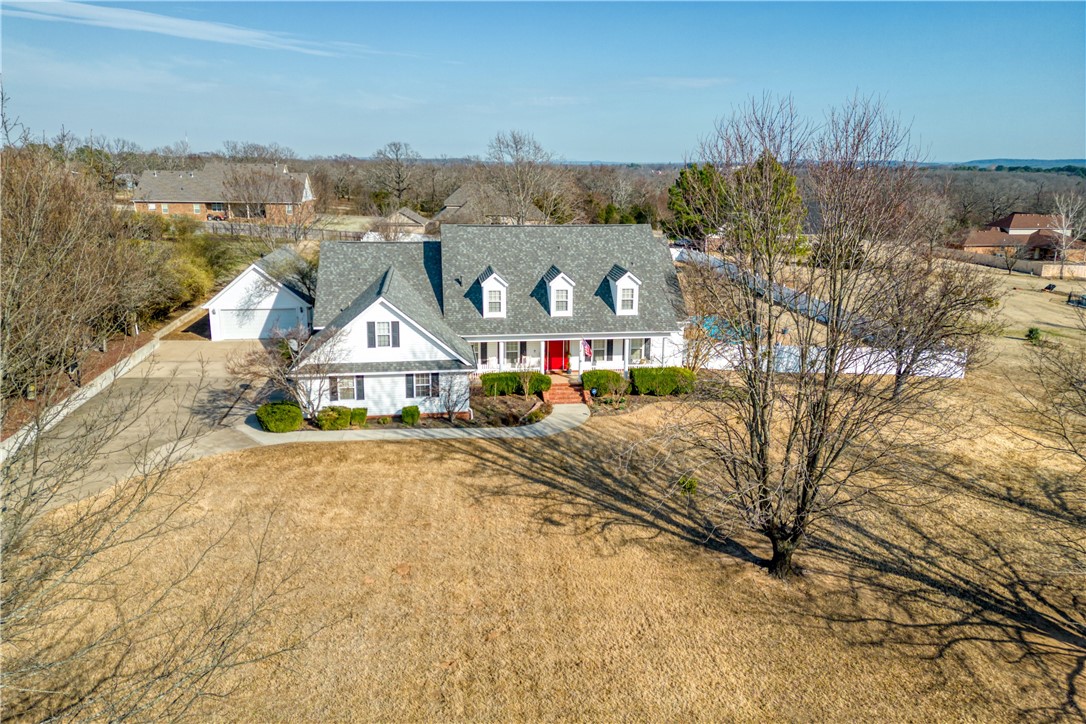 Beautiful family home on 1.5 acres in quiet neighborhood. 4 large bedrooms (2 upstairs and 2 down), 2 living areas, updated kitchen, wood floors on main level, built ins, plantation shutters, 3 floored attic spaces, and a large bonus room. Outside is an inground swimming pool, a tiled front porch, and a 2 car attached garage plus an additional 2 car detached garage. New roof, pool liner, and gutters in 2023.