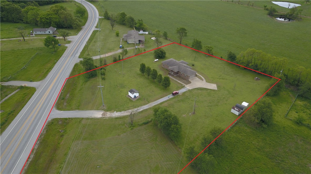 Great 2.27(+/-) level acres of Hwy 72 frontage and comes with 2 bed, 1 office, 2 bath, 2 car garage. Property could be rezoned commercial. Just off Hwy 72 & 549 bypass.