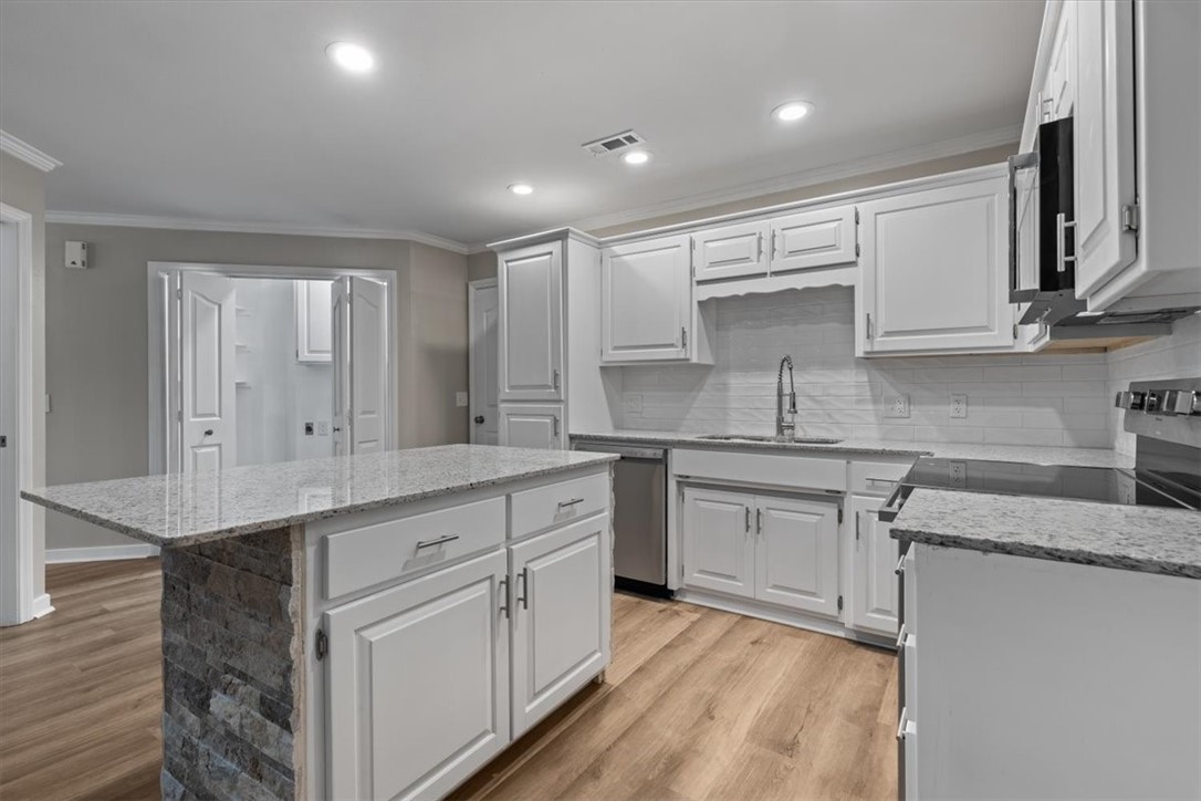 The location can't be beat in this all brick townhome located on a quiet, sleepy street where pride in ownership really shows! Almost everything is new starting at your freshly painted front door welcoming you to your new home. Upon entering you will embark on a journey across new LVP floors throughout main level. The fresh new kitchen off to the left with new granite counters, freshly painted cabinets, new stainless appliances, new hardware and fixtures. Kitchen also features an island in the middle as well as a large eating area. Laundry area and guest bathroom are just off kitchen with a large two car garage with new enameled floor coating and extra storage. The inviting living room has a peaceful fireplace and wall of windows for natural light leading to a private office with door to the fenced backyard with rock firepit. Big primary on main level has ensuite and walk-in-closet. Upstairs adds a flex space at top of stairs and a large bedroom, walk-in-closet, ensuite and attic access. New HVAC and Water Heater.