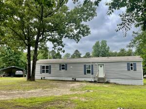 Secluded, peaceful home site only 15 minutes from town featuring a 3 year old mobile home with 2BR, 2BA. NICE. Check out the photos. 2 car Metal carport with large shop on the end of carport with electricity.. Enough wild life to keep the hunter happy. County water Also there is an RV hookup with 50 Amp.