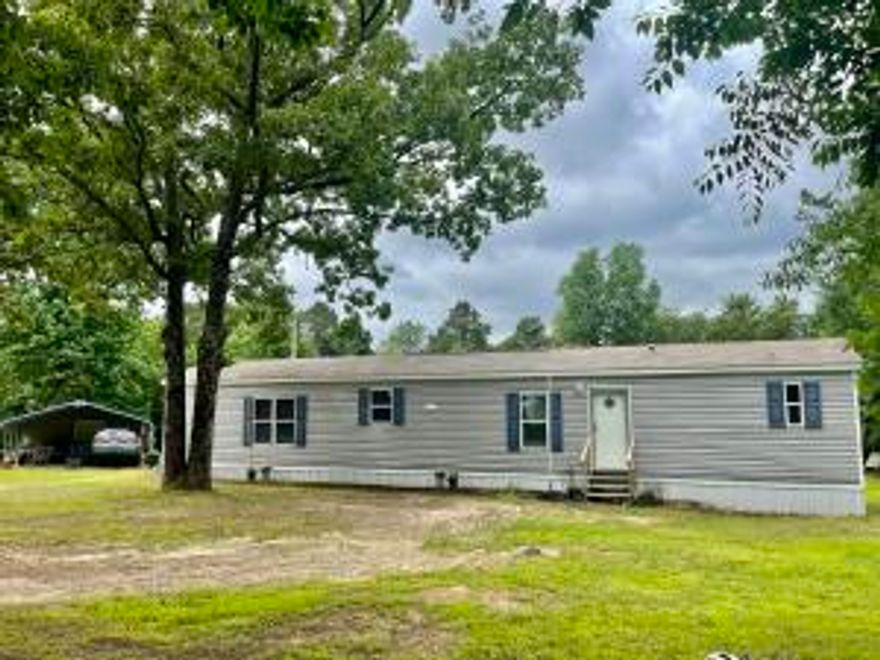 Secluded, peaceful home site only 15 minutes from town featuring a 3 year old mobile home with 2BR, 2BA. NICE. Check out the photos. 2 car Metal carport with large shop on the end of carport with electricity.. Enough wild life to keep the hunter happy. County water Also there is an RV hookup with 50 Amp.