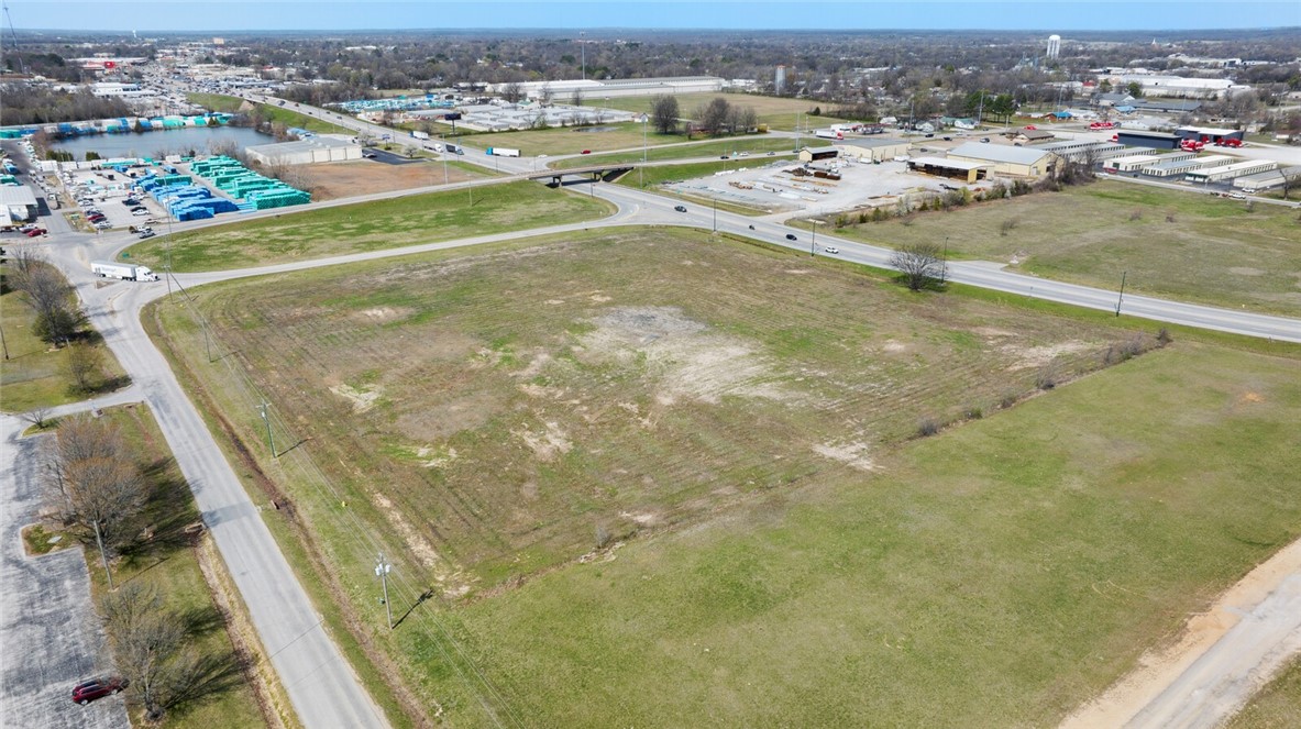 Excellent Hwy 412 corner acreage with additional frontage on AR 59 S and Quarter St. Would be great for Hotel, Movie Theater, Car Dealership or large Retail. Would consider subdividing in 1 acre plus parcels. Not far from Walmart Super Center, Lowe's, and new WOKA Adventure Water Park. Busy intersection in growing NWA.