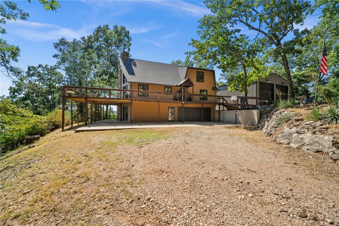 Welcome to your dream escape on Beaver Lake! This classic casual lake home offers a tranquil comfortable retreat blending its natural surroundings with STUNNING VIEWS, and is nestled in a secluded spot. Entry opens to living room with a stone wood burning fireplace, vaulted ceilings, and natural light pouring in through the windows that look out to the lake, and open kitchen. The deck offers fantastic views, & a Hot Tub. This 2,098 sqft home offers 180 degree views of the lake between Pt 6 & Pt 8, a 1,500 sqft new metal shop with 14' doors, and TWO 10x20 boat slips in the community dock. Recent updates include: All windows & sliders replaced, new bathroom fixtures & quartz countertops, cabinet hardware, interior completely painted, new light fixtures & ceiling fans, new KitchenAid stainless appliances, new carpet in July 2025, new shingles in the past 2 years, new gutters & leaf guards, new electrical panel for home & shop (both have 200 amp service & shop has a 50amp breaker for RV). A must see property.