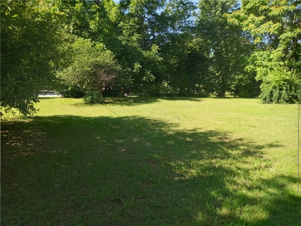 Vacant lot with Locust address, shade trees line the property of this large corner lot , established neighborhood with walking distance to shopping, School and and the Green Forest Square. All city utilities at the street. Apple trees at the drive way entry on the Western road frontage.