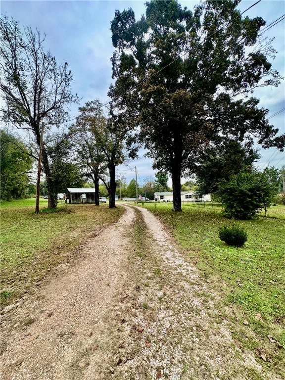 Experience the best of both worlds — peaceful country living within city limits! This large mobile home sits on over 6 beautiful acres, with Long Creek running along the north side of the property. The land features a large, flat, and landscaped yard, perfect for kids, pets, or gatherings. Enjoy warm summer days relaxing in the above-ground pool, and take advantage of the storage shop and outbuilding for all your tools and hobbies.Inside, you’ll find 3 bedrooms and 2 full bathrooms, including a spacious master suite with a walk-in closet, step-in shower, and soaking tub. The home has been refreshed with new paint throughout, updated light fixtures, and many improvements that make it move-in ready.With the convenience of being inside city limits but surrounded by the peaceful feel of the country, this property offers a rare blend of comfort, space