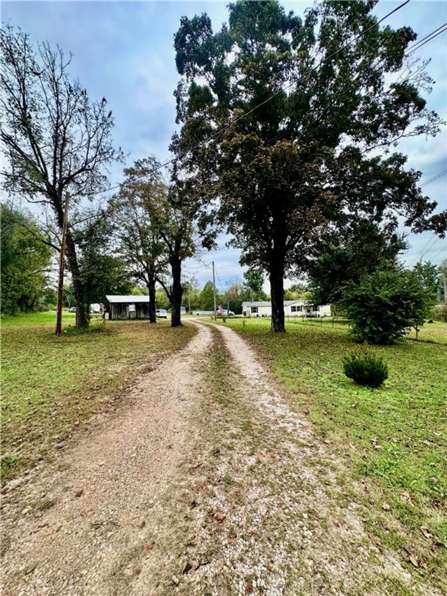 Experience the best of both worlds — peaceful country living within city limits! This large mobile home sits on over 6 beautiful acres, with Long Creek running along the north side of the property. The land features a large, flat, and landscaped yard, perfect for kids, pets, or gatherings. Enjoy warm summer days relaxing in the above-ground pool, and take advantage of the storage shop and outbuilding for all your tools and hobbies.Inside, you’ll find 3 bedrooms and 2 full bathrooms, including a spacious master suite with a walk-in closet, step-in shower, and soaking tub. The home has been refreshed with new paint throughout, updated light fixtures, and many improvements that make it move-in ready.With the convenience of being inside city limits but surrounded by the peaceful feel of the country, this property offers a rare blend of comfort, space