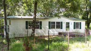 Located between Harrison & Branson. 3 bedroom 2 bath 28 x 48 doublewide mobile home on 1 acre. Deck and large trees. Needs a little TLC.