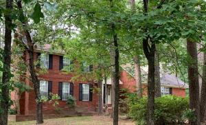 Great neighborhood and great home. Recently completed updated. Den and living both with fireplaces. Large kitchen with all new appliances. Formal dining and breakfast area. 4 bedrooms, 2 1/2 baths. Large screened porch with brick flooring plus patio. Hardwood floors throughout. Detached building with loft perfect for small shop.