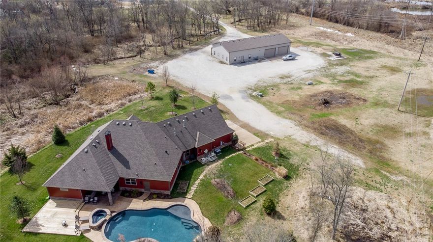 Truly a one of a kind set up located in Bentonville on over 6 acres! Completely custom home with a 3,600 square foot shop with offices. Amazing in-ground gunite pool and hot tub that is set up to entertain! Following the private driveway that leads you back in to 6.77 acres of privacy surrounded by trees and lush landscaping. Features include a split floor plan, Marble Rainforest Marble and Custom granite countertops throughout the kitchen, walk in pantry, dual head walk in shower in master, large wrap around master closet, butler’s pantry, and a farmhouse sink & additional sink in kitchen area. Shop includes reception area, two offices, granite throughout, full kitchen and dual bathrooms, heated and cooled with roll up garage doors. Close to food, shopping, & parks. Bentonville school district, minutes to downtown Bentonville. This property has it all. Welcome to Palmer Creek!