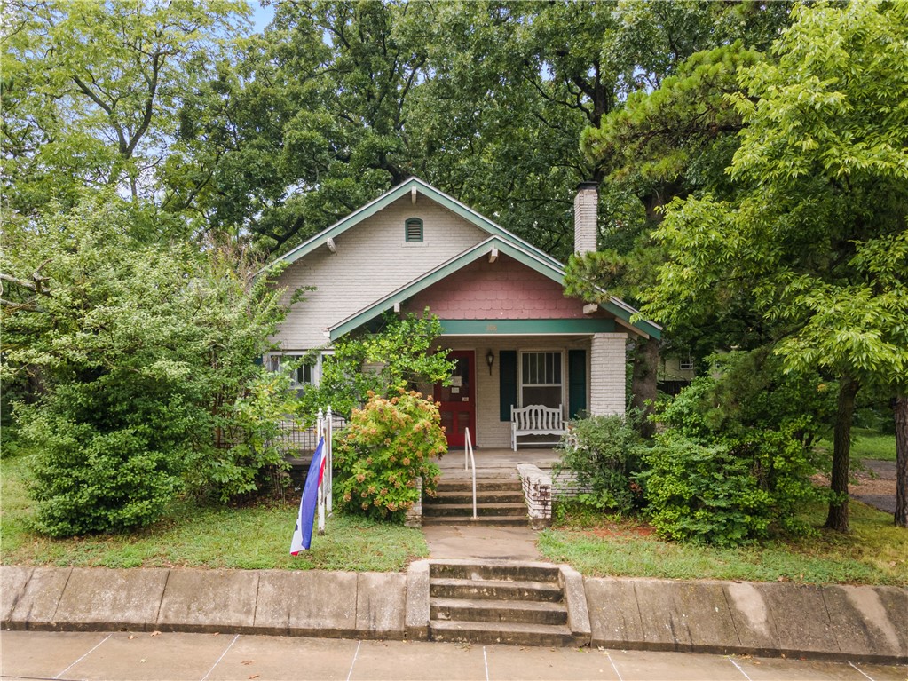 A true gem in the heart of Siloam Springs. A beautiful historic home walking distance to downtown where you can experience all the amazing shops and restaurants Siloam has to offer! Incredible hardwood floors, a large front porch to sit and relax, beautiful wood trim, a large sunroom, the possibilities are endless! Mature trees on this lot that provides great shade! It features a detached garage/workshop that has electric. Close to schools including John Brown University. The library, Memorial Park and splash pad are just across the street! The City, Main St Siloam, and the Chamber host so many great events you can enjoy within a few minutes walk! Owners have ran a business in the home for 20 years. It could continue as commercial too if you wanted to have a business versus residential. Currently zoned commercial/historic but can be changed to residential/historic per seller.