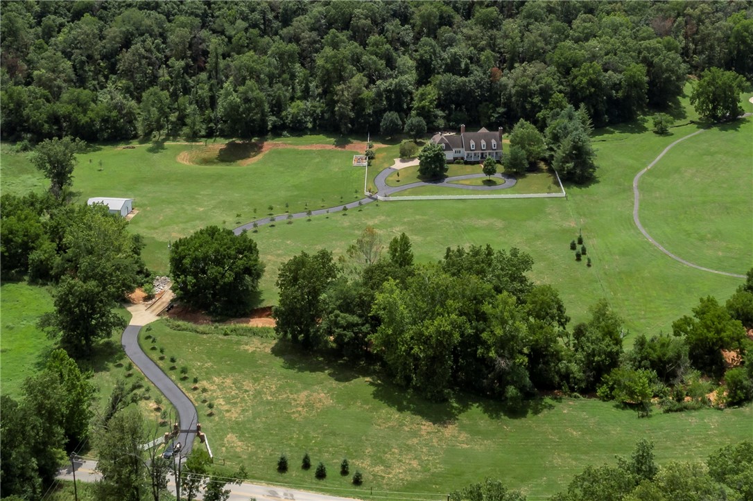 Rare Large Acreage Estate in North Bentonville! āRedbud Estateā is a Southern Living Inspired Dream Home situated on 16.85 acres in the desirable area of Punkin Holler near Coler Creek Mountain Preserve! This one-of-a-kind property is minutes from Downtown Bentonville and is a melody of southern-living eloquence intertwined with sleek and modern updates! Driving up the long winding tree lined driveway leading to the historic inspired built home, you are greeted with privacy and the sights and sounds of nature. Gorgeous interior with library, formal dining, Chefās kitchen, and private Master Suite with luxurious spa-inspired bath-a stunning wet room/steam shower/soaking tub! Upstairs has additional bedrooms and flex rooms. The grounds feature a wet weather creek, 40 x 40 barn, beautiful mature trees and landscaping, heated pool, hot tub, firepit, and amazing outdoor living and entertaining area! This is a one-of-a-kind rare private retreat in the heart of NW Arkansas!