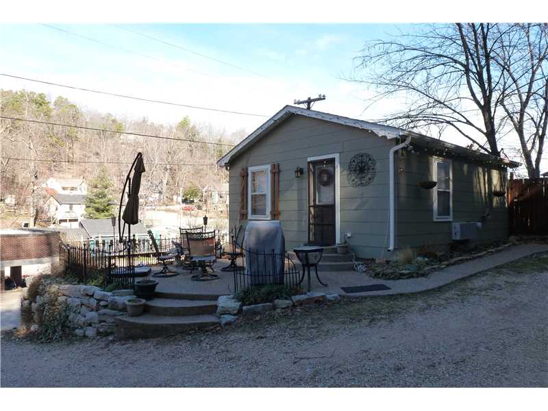 Cute downtown cottage, this little doll house is perfect for that weekend getaway. Located in the heart of the downtown restaurant district, it was completely remodeled in 2007, Hardwood and tile floors, new kitchen cabinets, corner fireplace!,Landscaped yard and with beautiful rock bluffs with privacy fence and outdoor Hot Tub! Offstreet parking!