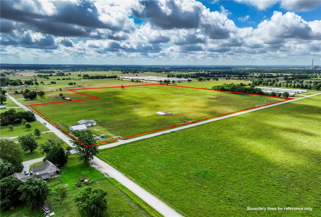 If you are looking for level land just outside of Gentry city limits with no deed restrictions, this could be the perfect location for you! This 34.91 acres fronts both Bloomfield North Road and Floyd Moore Road. Water, electric and propane are already on site. The main water line of Gentry runs along the front of the property. Comes with a 42 x 50 Equipment Barn with a 12 x 50 lean-to attached and a 66 x 50 Workshop on a concrete slab. The workshop has central heat, one hydraulic car lift and three 12 x 10 doors for large equipment. Propane tank is owned. Great property for developing. Has so much potential and endless possibilities! Don't miss out!