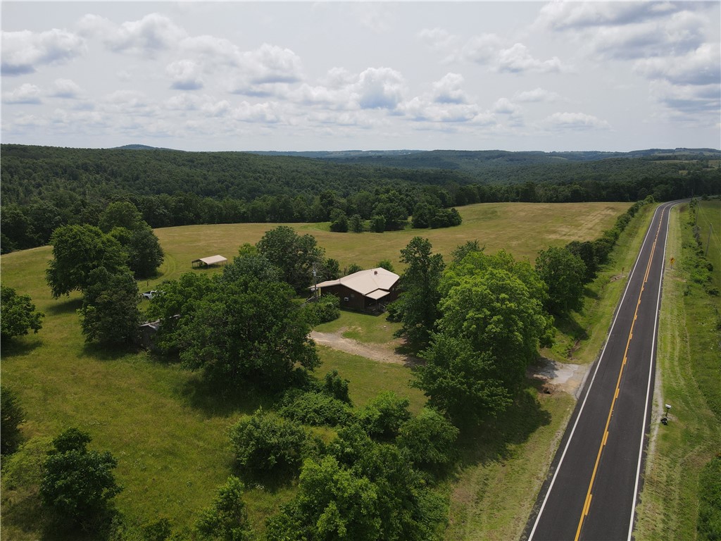 This beautiful 40 acre +/-property offers a rare blend of functionality and natural beauty. It features a home with shop, two wells, a pond, and access to both city water and high-speed fiber internet. The land includes productive pasture, a hay field, a garden area, and a mix of open and wooded ground, perfect for recreation or homesteading. A creek, natural springs, and scenic bluff overhangs add to the charm and character of the land. With paved Highway 27 frontage, easy access is a bonus, and the abundant wildlife makes it ideal for hunting and outdoor enjoyment.