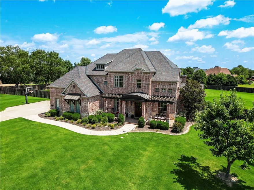 Stunning executive home in Stonebriar! It is rare for a home this large to be able to capture a “homey” feeling such as this one. Step onto the lovely front porch to welcoming entry, formal dining, office w/French doors. You will be wowed the moment you enter the kitchen/living/breakfast room w/stunning views to your backyard oasis! Covered patio w/gas grill, small fridge, wood burning fp & gunite pool. So much space in the fenced 1.45 acres to enjoy! Kitchen is stunning! Brick surrounds the double oven w/8 burners. Under counter microwave, butlers’ pantry, walk in pantry, & more. Study nook, mud room nearby. Primary bedroom has sitting area, spa like bath w/custom shower, designer closet, & laundry chute! Additional bedroom down, w/nearby full bath. Up the beautiful staircase to a 2nd living area, & a media room with amazing custom wet bar. Such fun to entertain or just enjoy! 3 bedrooms upstairs w/clever private bathroom space for each. Although you may never want to leave, schools & hwy 49 access are nearby!