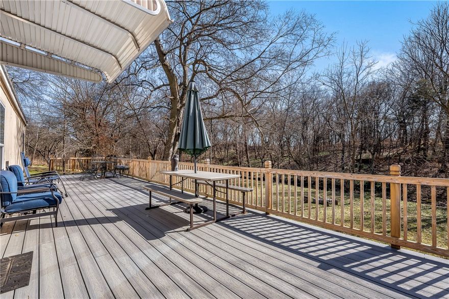 If you are looking for an affordable home in a gorgeous, natural setting then you've found it!  This picturesque acreage opens up behind the home like a peaceful meadow with the seasonal creek to complete the setting.  Welcome home to your modern and efficient home with a well designed flow to the outdoor and indoor spaces.  Extensive drainage work and landscaping/retaining walls make this a low maintenance home site, the massive back deck is where you'll want to spend your down time, and the 3 bedroom floor plan has room for everyone.  Picture yourself enjoying family time by the firepit, swinging or splashing in the creek.  Quiet area and lots of privacy, with a screen of trees behind the home that create a green canopy wall most of the year. This modular home is on a permanent foundation so it should easily qualify for all types of loans.  The large metal shed will convey and appliances in the home (and some furniture pieces) are negotiable. Come see this beauty while you still can and you won't want to leave!