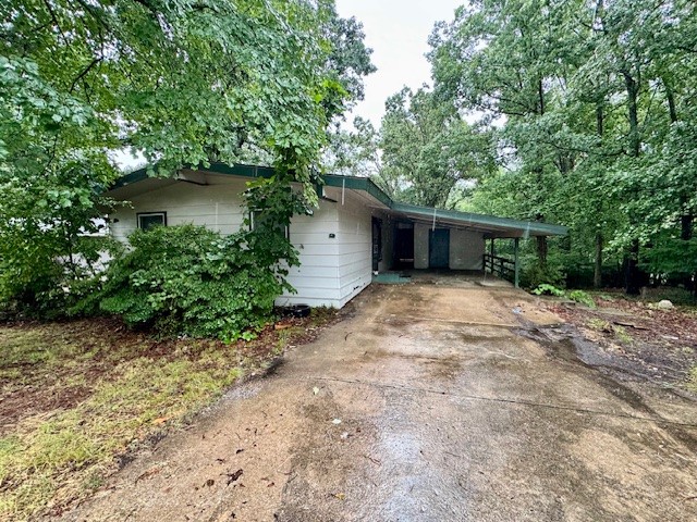 Discover this cozy 2 bedroom home featuring an open living room filled with natural light! Enjoy the peaceful wooded surroundings from the large walk out deck - perfect for relaxing or entertaining. The property also includes a carport with a spacious storage closet, combining convenience with charm. Tenants responsible for all utilities, washer, dryer, and lawn maintenance. Apply online at www.nwarealtypm.com. We process applications as we receive and once an application is approved, we reach out for deposit. Deposit secures the unit not the application. Please be aware of scams. Our application process is to be paid online through a secure portal, and we do not accept cash, CashApp, Venmo, and/or PayPal.