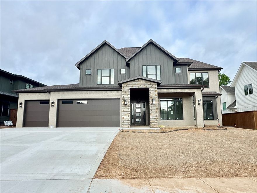 Located in the perfect location w/ easy access to Coler Mountain Bike Preserve trails, schools, downtown Bentonville & more. The heart of this haven is undoubtedly the chef's kitchen, sprawling island, vegetable sink, 5-burner/double oven gas range, quartz counters/backsplash, walk in pantry, and custom stained walnut cabinets. Living room centers around stunning tile gas fireplace, enveloped by oversized windows that bathe the space in light. Adjacent, the dedicated dining area is positioned for a seamless flow. Retreat to the primary suite, where oversized windows invite in sunlight & spa-inspired bath with a walk-in tile shower featuring double showerheads, soaking tub, double sinks, smart mirrors & walk-in closet with direct access to the laundry room. Study with French doors and beams and secondary suite on the main level. Upstairs reveals a generous bonus room with a wet bar and two secondary bedrooms. Enjoy the oversized covered patio overlooking the fenced backyard. $3,000 if you use the preferred Lenders