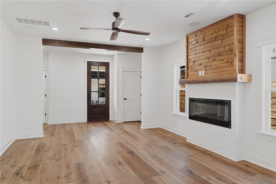 Stunning new construction home in Downtown Bentonville. This charming pocket neighborhood boasts quality, high end finished homes within close proximity to all things downtown. Just minutes by bike or foot to the square, Crystal Bridges, the trail system, Compton Gardens, restaurants, shopping, & entertainment. Airship coffee's newest location will be your next door neighbor in spring of 2023!!! Enjoy the clean, modern color palette along with gorgeous hardwood flooring throughout the entire main floor & the Primary Suite! Natural light pours in throughout all the windows of this beautiful home. GE Profile appliance package includes the matching refrigerator, plus modern roller shade window coverings throughout! The Primary suite is truly that--a suite with lots of space, accent wall, radiant heated bathroom floors, double vanities, gigantic double shower w/frameless glass, private toilet closet, & his and hers closets. This house is move-in ready & waiting for you to enjoy a beautiful fall season in the Ozarks!