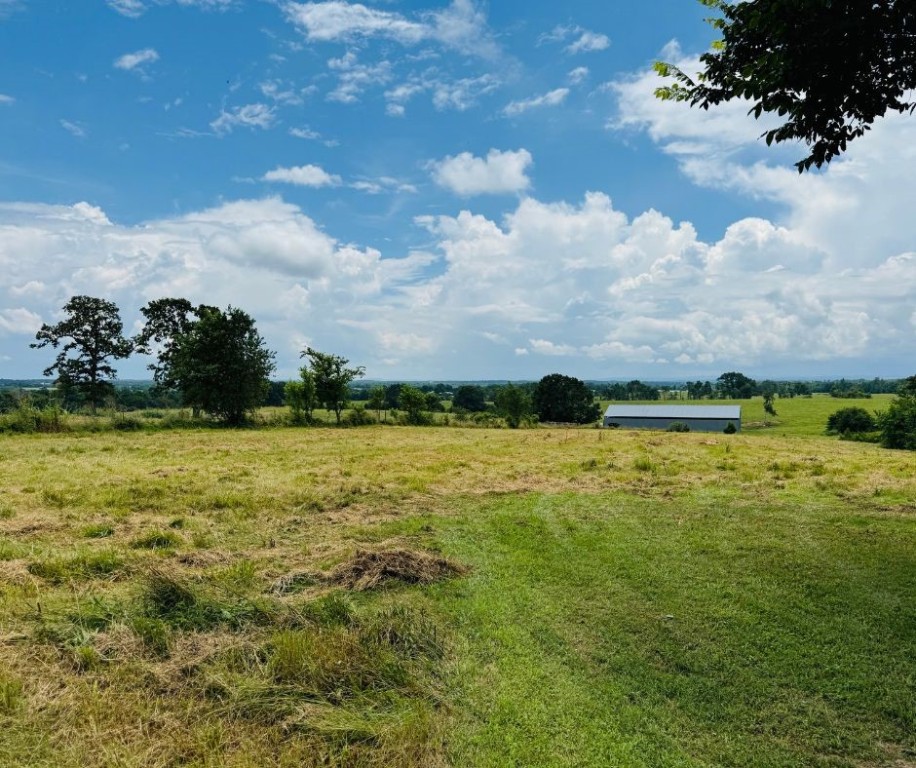 This cleared and build-ready 5-acre tract offers stunning Ozark Mountain views and high-visibility frontage along Clifty Highway in Madison County. Located just 15 minutes from Huntsville and 15 minutes from Eureka Springs, the property sits along a high-traffic corridor, making it ideal for a variety of potential uses including commercial development, short-term rentals, or a private homestead. The land is equipped with essential utilities including rural water at the road, multiple wells, electric on-site, and two septic systems. With no deed restrictions, flexible access, and panoramic scenery, this parcel provides a rare opportunity to invest in one of Northwest Arkansasās most scenic and versatile locations. Home with 5.36 acres listed together MLS1314697