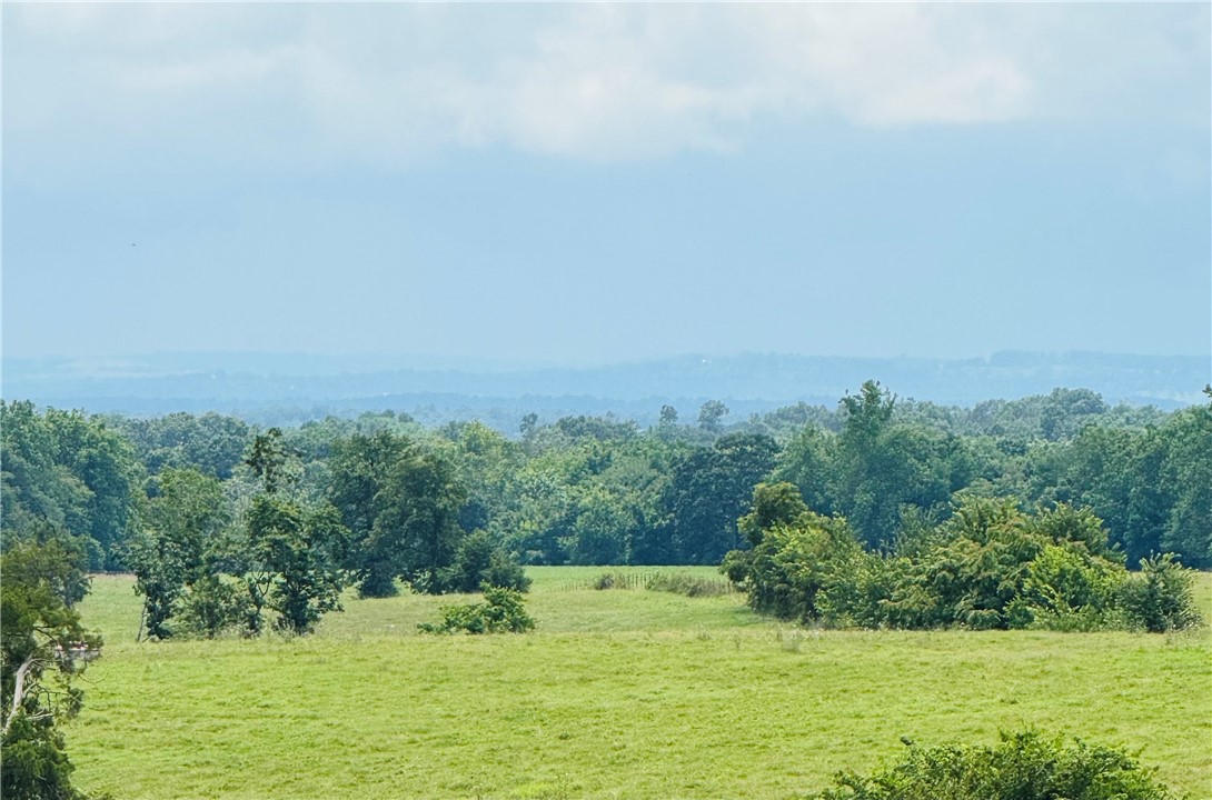 Discover 4.84 acres of prime land in Madison County, perfectly positioned to enjoy all that Northwest Arkansas has to offer. This cleared, build-ready tract delivers panoramic Ozark Mountain views in every direction and boasts high-visibility frontage along Clifty Highway.
Just 15 minutes from both Huntsville and Eureka Springs, the property’s location along a busy corridor makes it ideal for commercial use, short-term rentals, or a private homestead retreat.
Utilities are already in place for a seamless start, including rural water at the road, multiple wells, and on-site electric. With no deed restrictions, flexible access, and unbeatable scenery, this property is a rare opportunity to create something truly special in one of Northwest Arkansas’s most scenic settings.